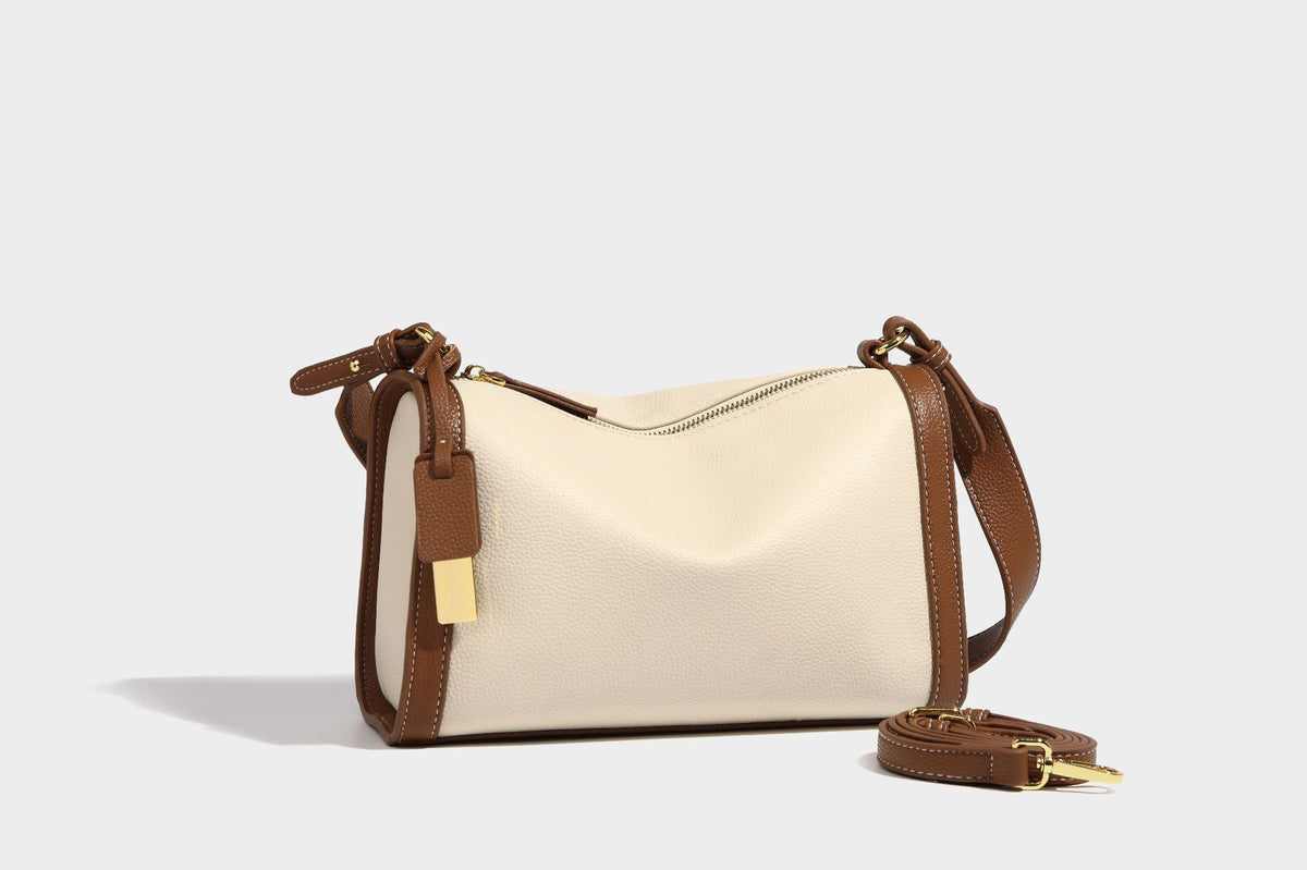 Structured two-tone shoulder bag with pebbled leather-look finish, contrast trim, top zip closure, and gold-tone hardware