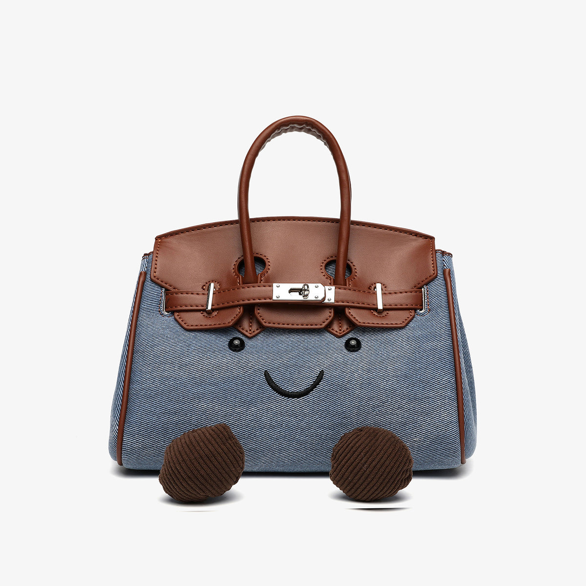 Small structured trapezoid satchel bag with smiling face motif, pom-pom accents, brown leather-look trim, silver-tone, detail