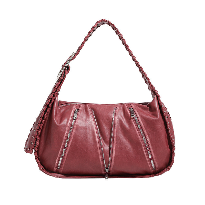 Slouchy hobo shoulder bag with wide braided eyelet strap, multiple front zip compartments, and silver-tone ring buckle