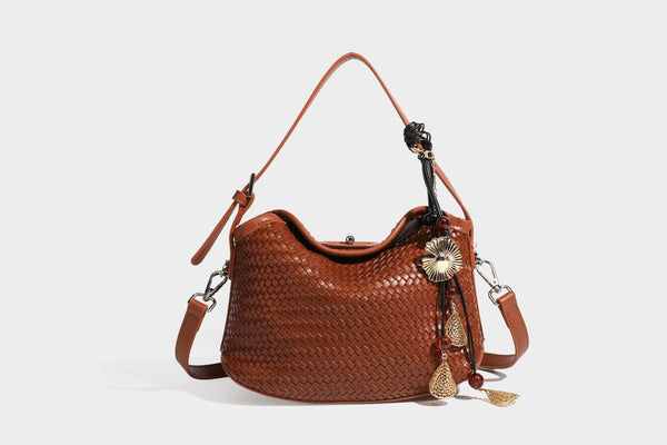Small woven-look leather-look flap shoulder hobo bag in burgundy with silver-tone hardware and decorative tassel charm