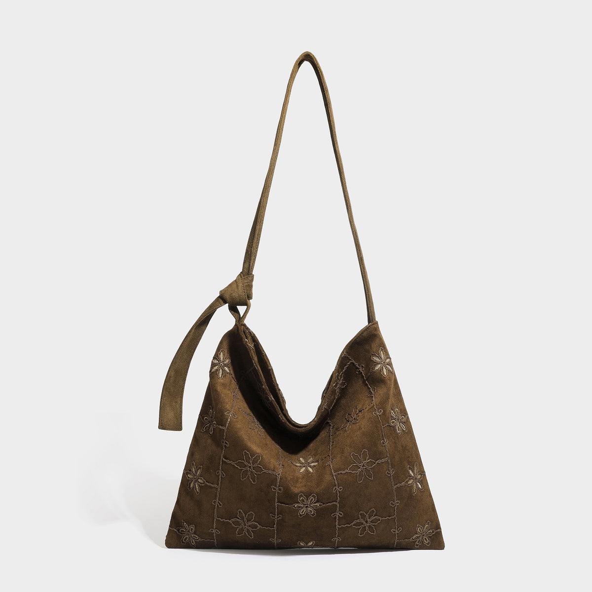 Slouchy hobo shoulder bag in dark brown suede-look finish with tonal floral embroidery and long knotted single strap, front