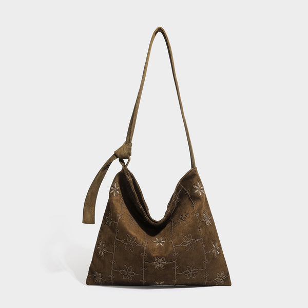 Lässig weich fallende Hobo-Schultertasche in dunkelbrauner Velourslederoptik mit Ton-in-Ton-Blumenstickerei und langem, geknotetem Einzelriemen, Vorderansicht