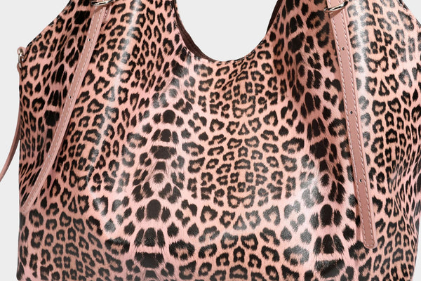 Large leopard print shoulder tote bag with glossy finish, long double straps, front zip pocket, silver-tone hardware, and