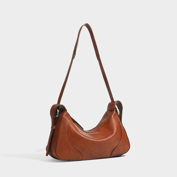 Slouchy crescent hobo shoulder bag in dark brown pebbled leather-look finish with zip top and long shoulder strap, detail