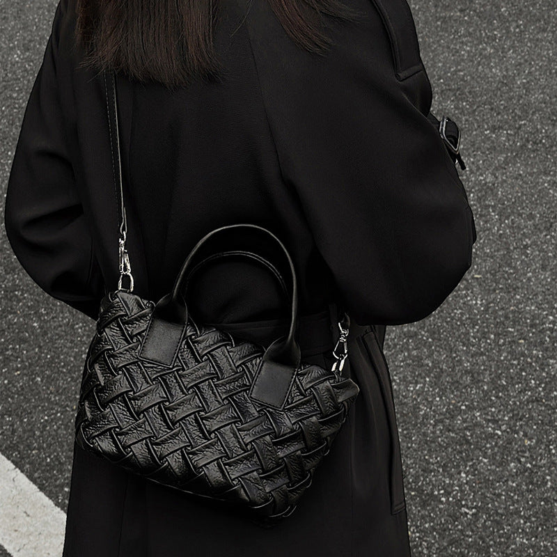 Small black glossy woven tote bag with dual top handles and detachable shoulder strap, detail view 5
