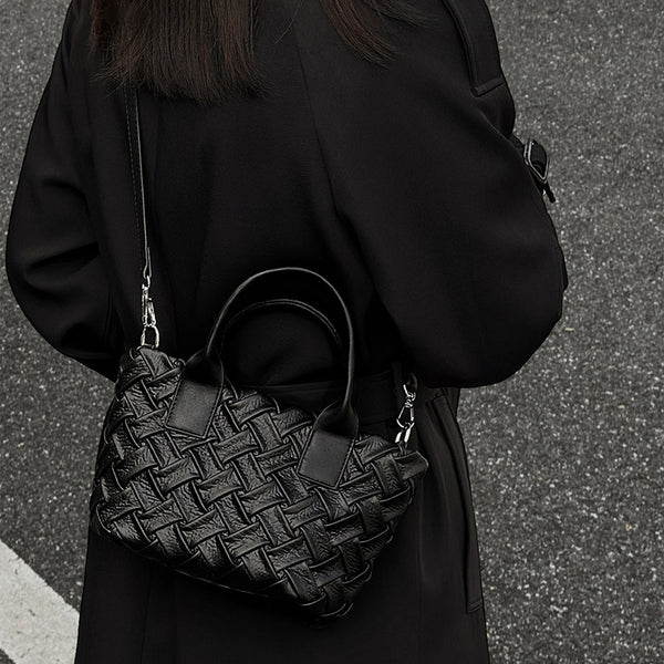 Small black glossy woven tote bag with dual top handles and detachable shoulder strap, detail view 5