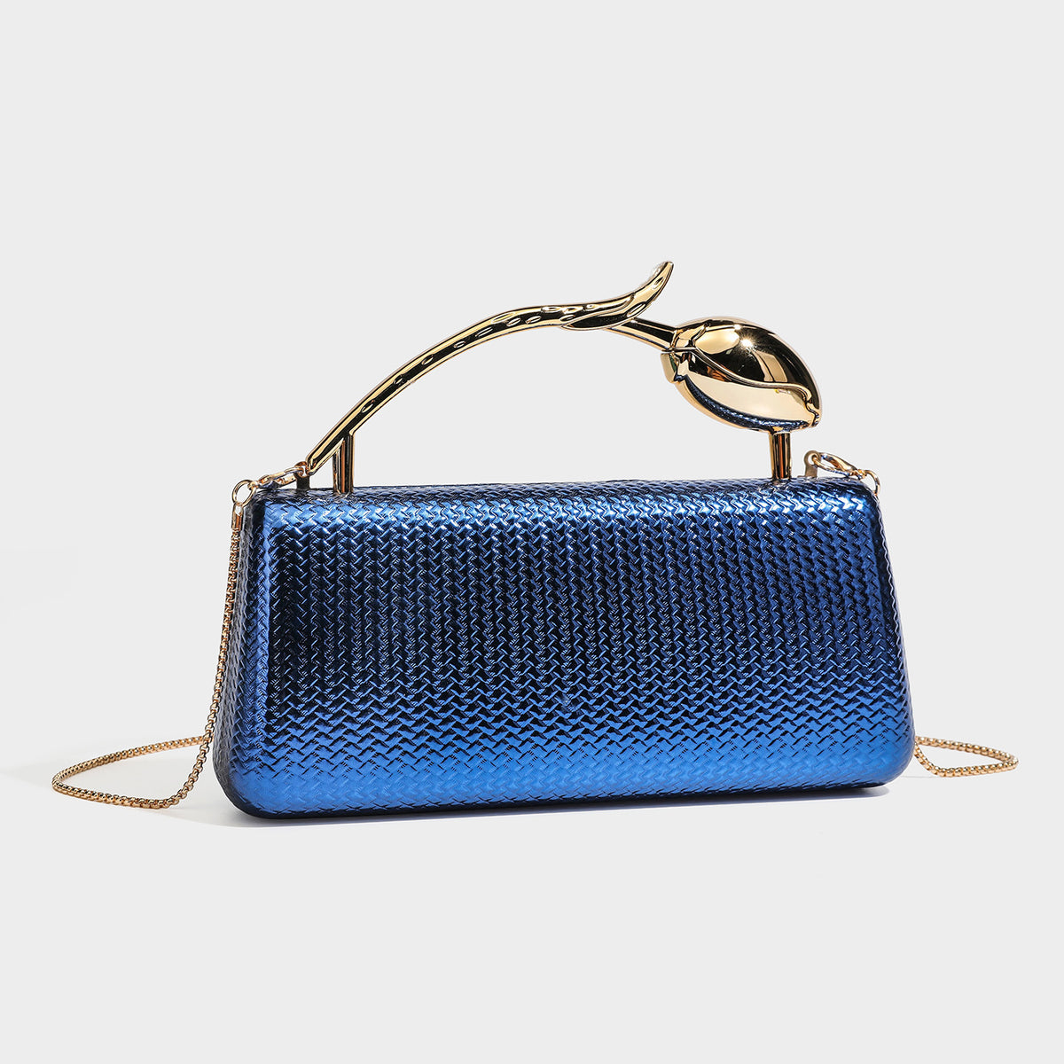 Structured rectangular metallic woven clutch bag with sculptural gold-tone leaf top handle and detachable chain strap, detail