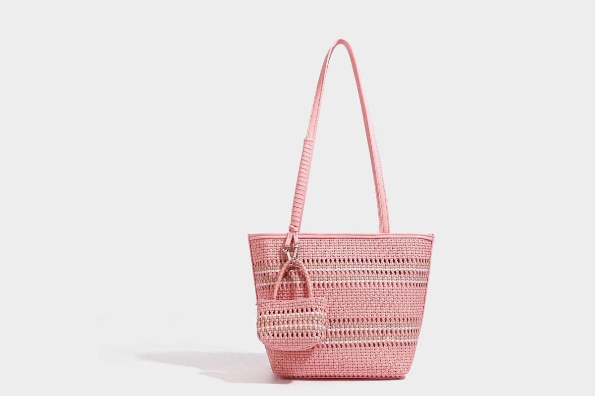 Large structured woven tote bag with striped basket-weave finish, long shoulder straps, and detachable mini pouch charm