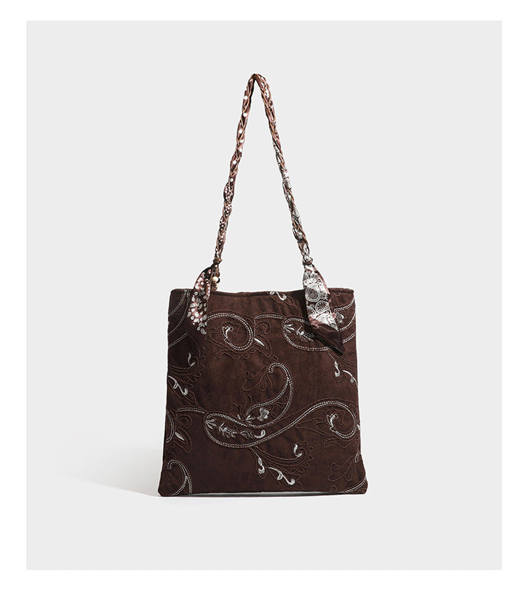 Brown suede-finish tote bag with paisley embroidery and braided fabric-ribbon shoulder strap, detail view 17