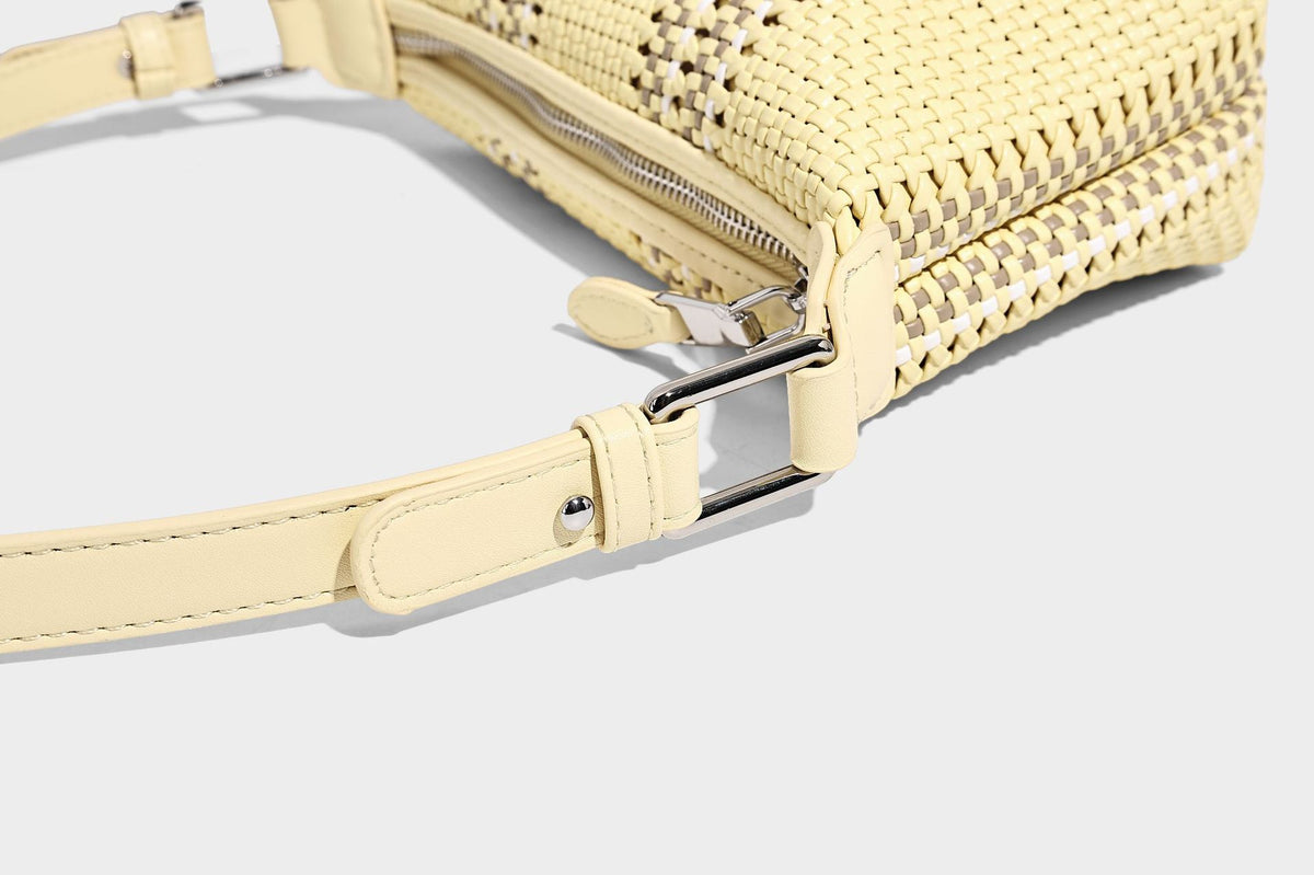 Small woven crescent shoulder bag with leather-look trim, zip closure, silver-tone ring hardware, and beaded tassel charm