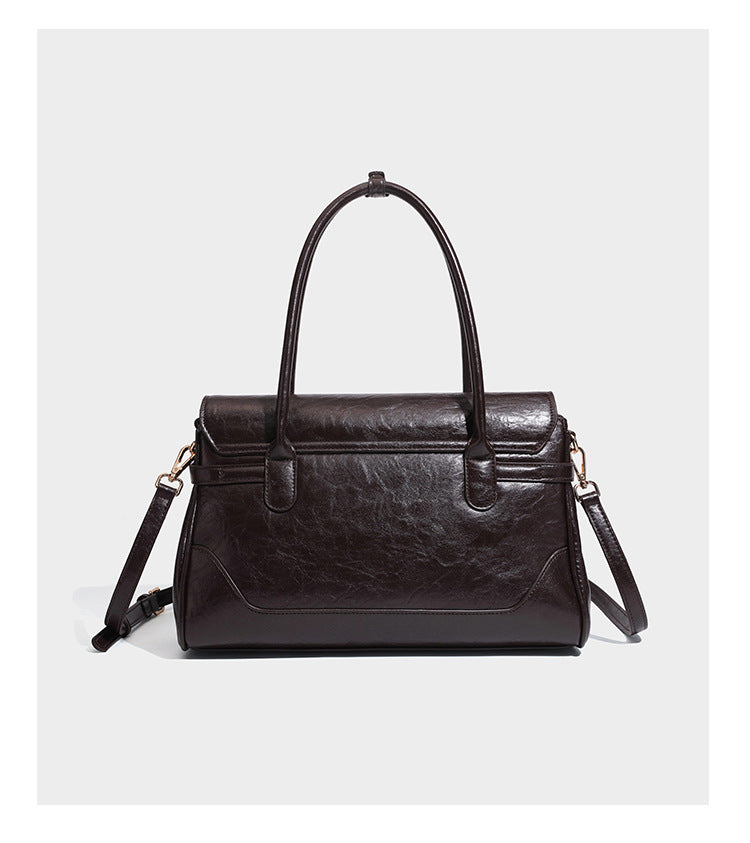 Structured glossy leather-look satchel bag with flap closure, gold-tone buckle accents, double top handles, detachable