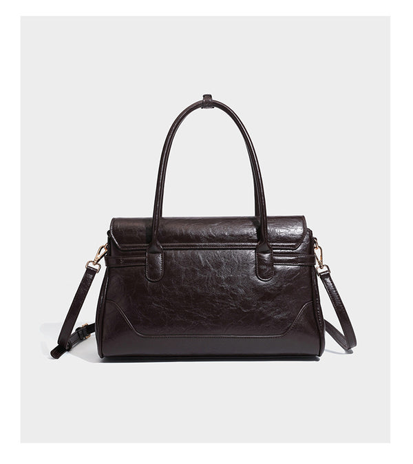 Structured glossy leather-look satchel bag with flap closure, gold-tone buckle accents, double top handles, detachable