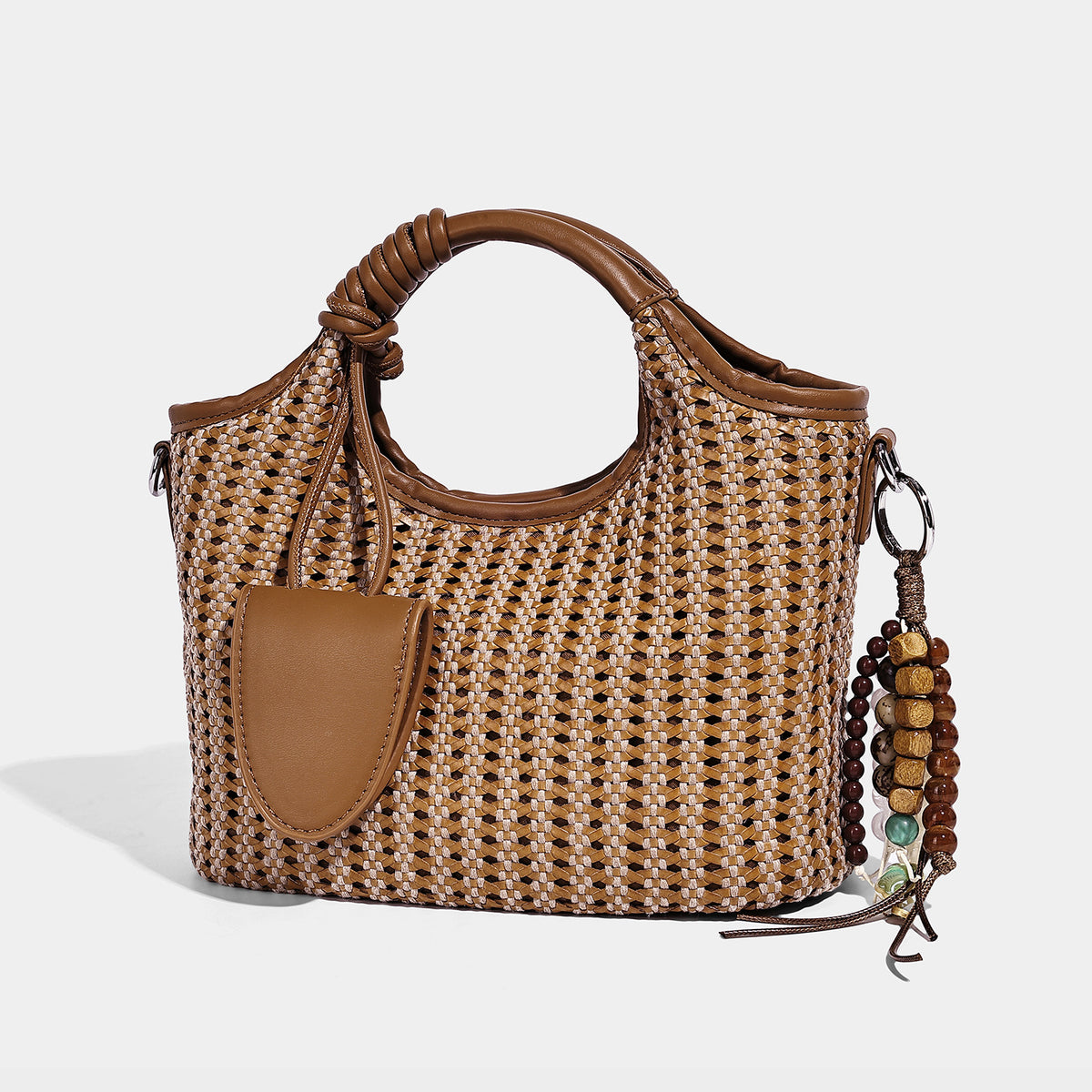 Small structured woven tote crossbody bag with ring top handle, leather-look brown trim, front patch pocket, and detachable