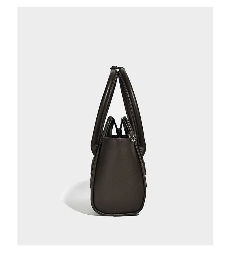 Small structured woven-panel mini tote bag with double top handles and detachable crossbody strap in matte leather-look