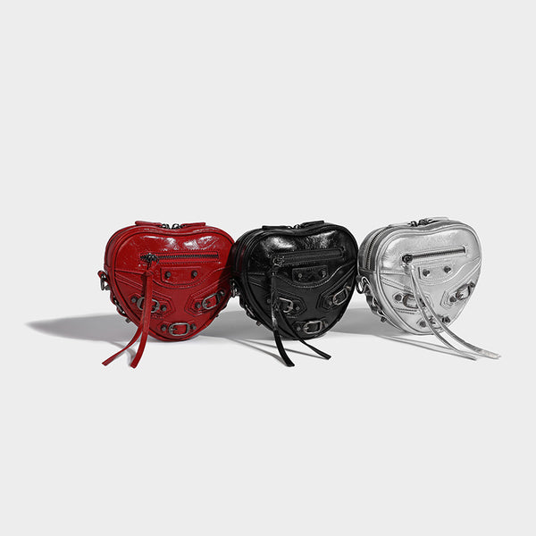 Mini heart-shaped crossbody bag with glossy crinkled finish and moto buckle hardware, front view