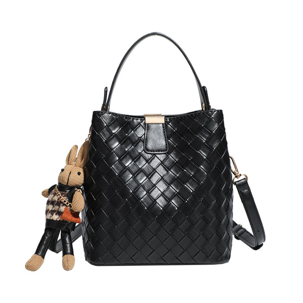 Black woven leather-look bucket bag with gold-tone clip closure, top handle, detachable shoulder strap, and knit bunny charm