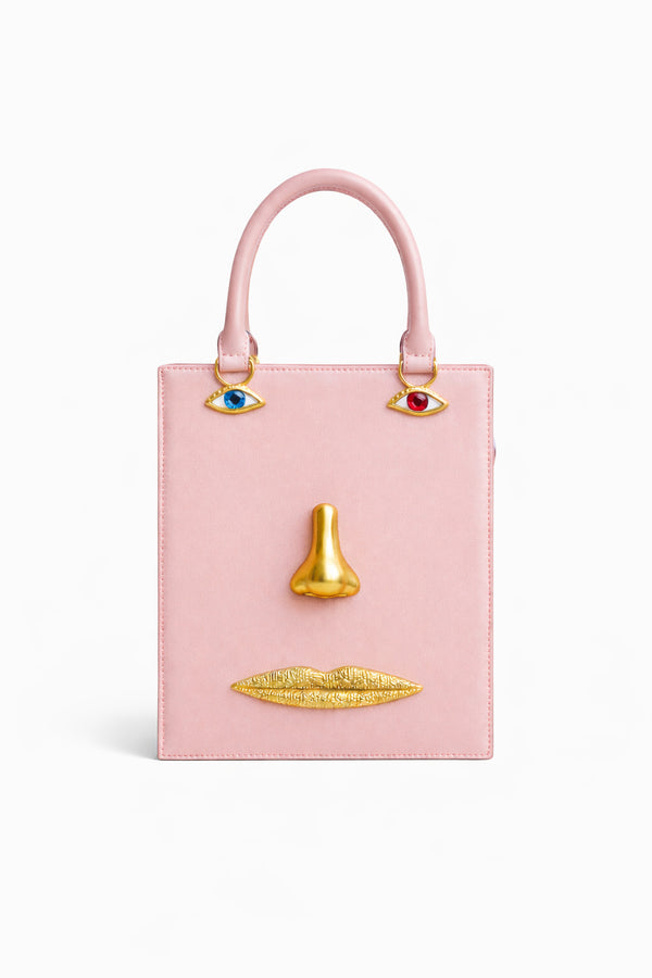 Structured rectangular top-handle bag in tan leather-look finish with gold-tone sculptural face hardware including