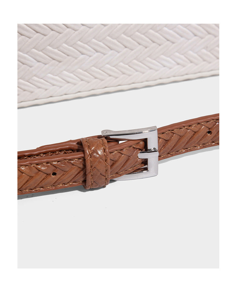 Structured woven-texture tote bag with brown braided top handles, decorative tassel charm, and detachable shoulder strap