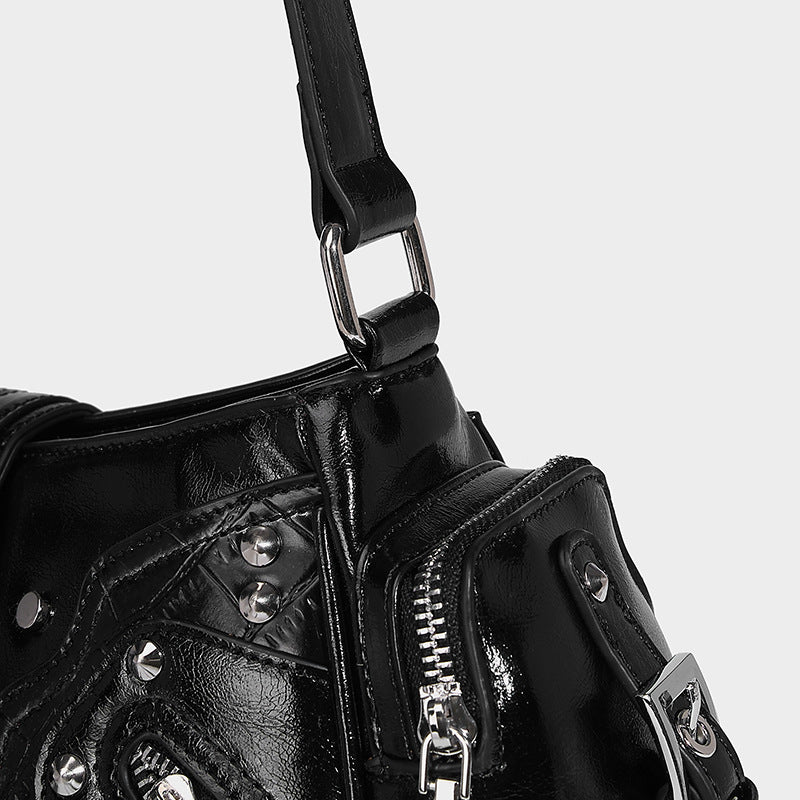 Compact glossy leather-look crossbody bag with silver studs, buckle hardware, and multiple zip pockets, detail view 21