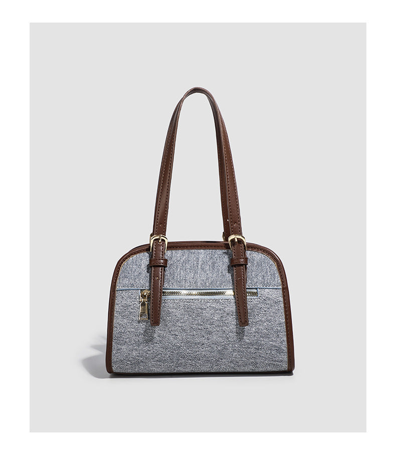 Small structured grey fabric shoulder bag with brown leather-look trim, gold-tone hardware, dual top handles, and detachable
