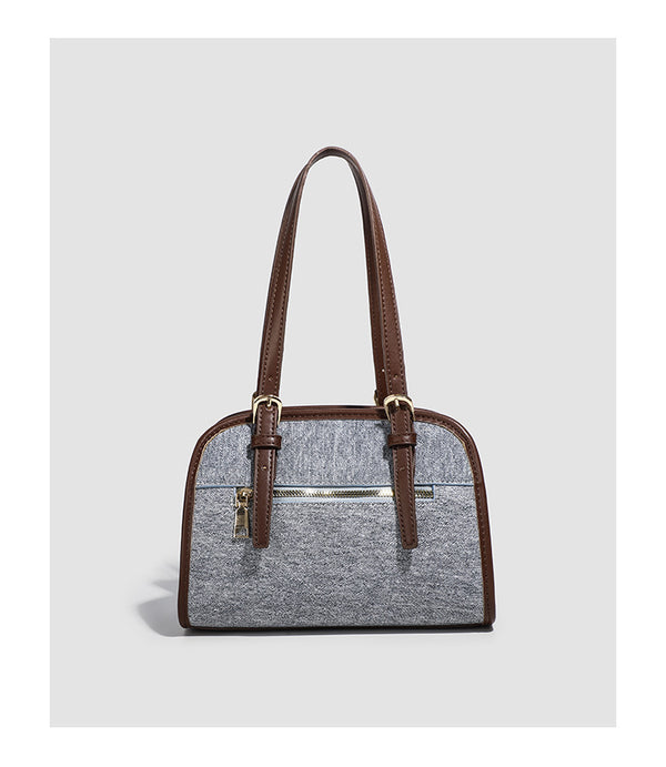 Small structured grey fabric shoulder bag with brown leather-look trim, gold-tone hardware, dual top handles, and detachable
