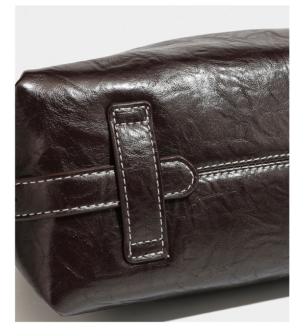 Slouchy hobo shoulder bag in glossy crinkled leather-look finish with zip-top closure and silver-tone ring hardware, detail