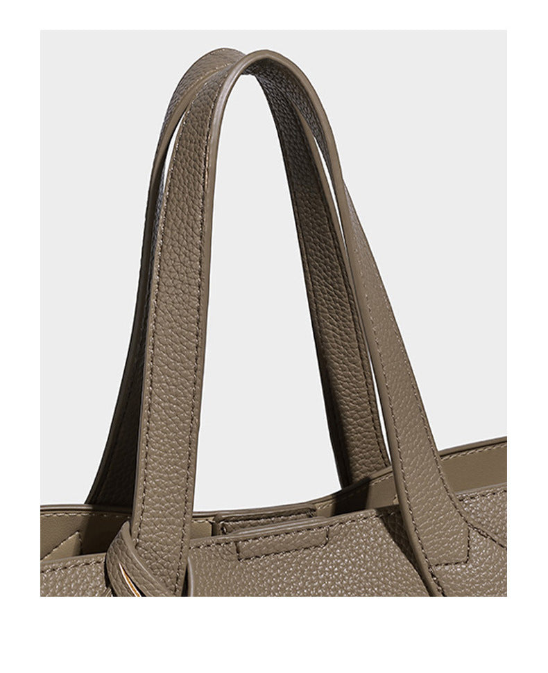 Compact pebbled bucket tote bag with elephant charm, twin top handles, and detachable crossbody strap, detail view 13