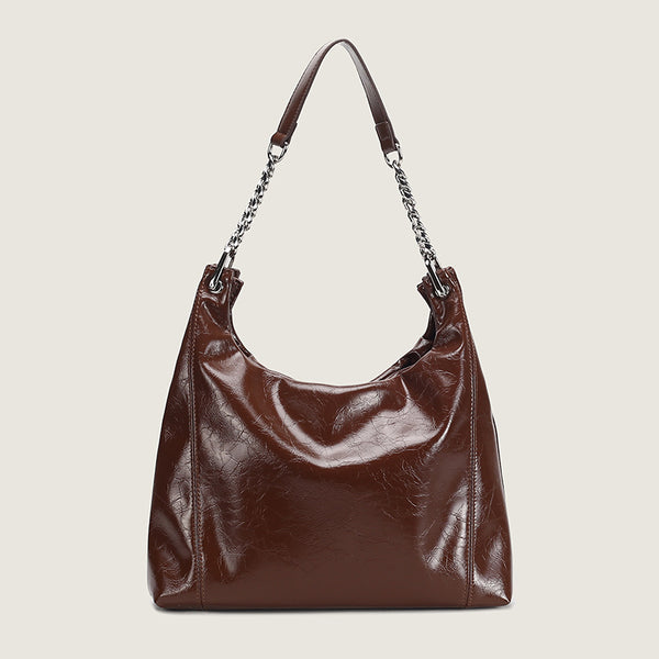 Glossy crinkled leather-look slouchy hobo bag with silver chain-and-leather shoulder strap and open top, detail view 2