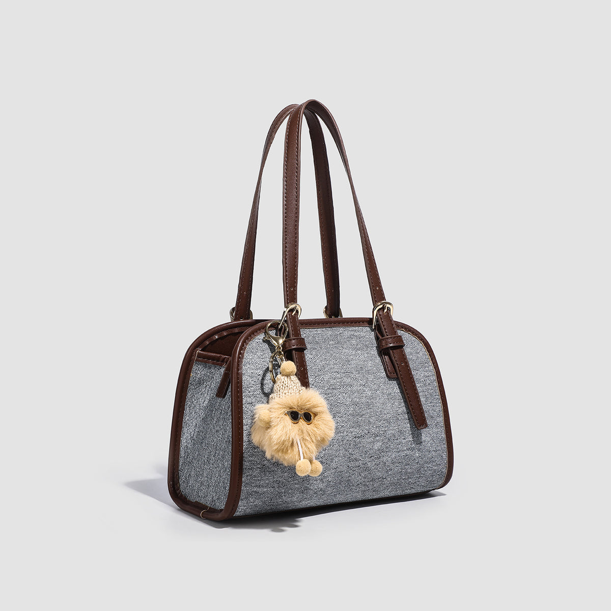 Small structured grey fabric shoulder bag with brown leather-look trim, gold-tone hardware, dual top handles, and detachable