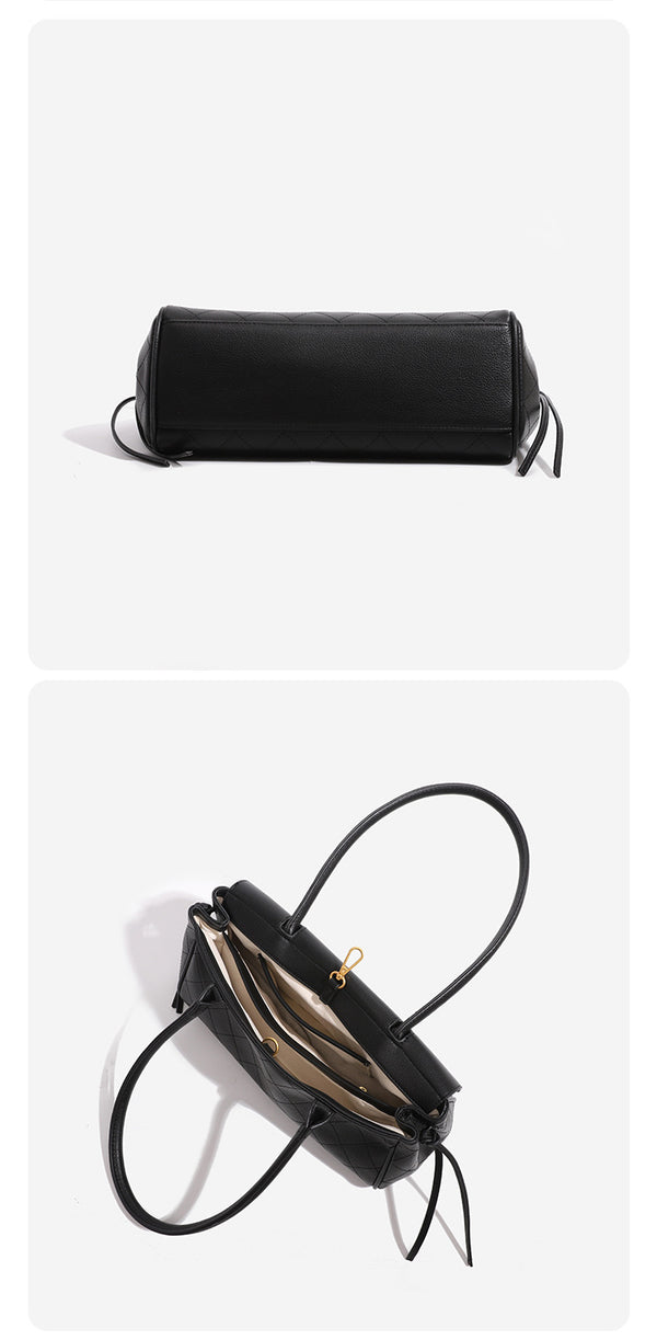 Structured black baguette bag with diamond-quilted front panel, gold-tone turn-lock flap closure, and dual looped top