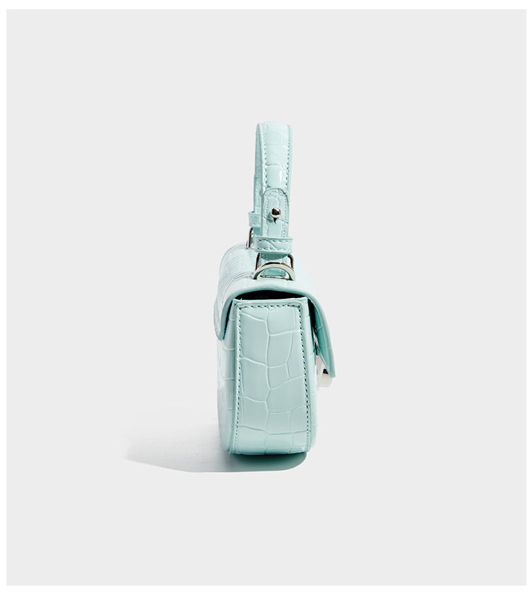 Glossy croc-embossed mini saddle bag with silver-tone turn-lock clasp and short top handle, detail view 9