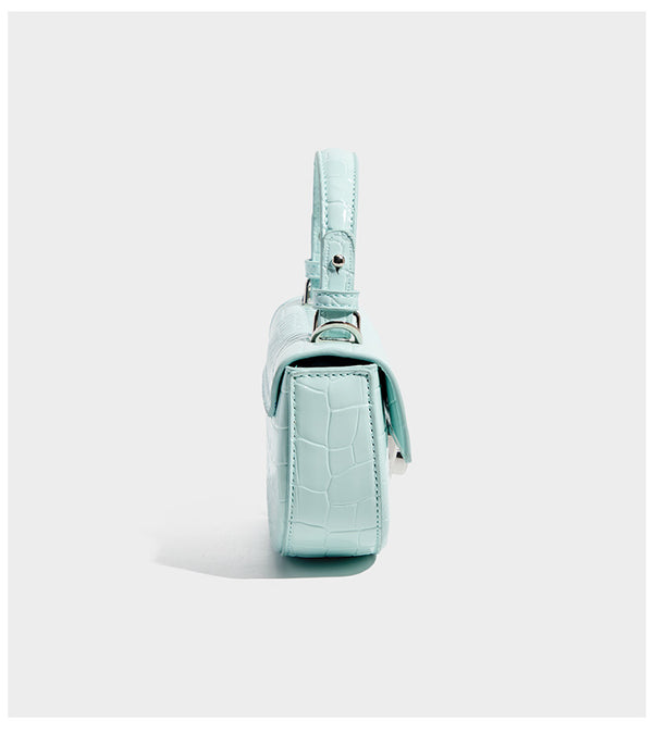 Glossy croc-embossed mini saddle bag with silver-tone turn-lock clasp and short top handle, detail view 9