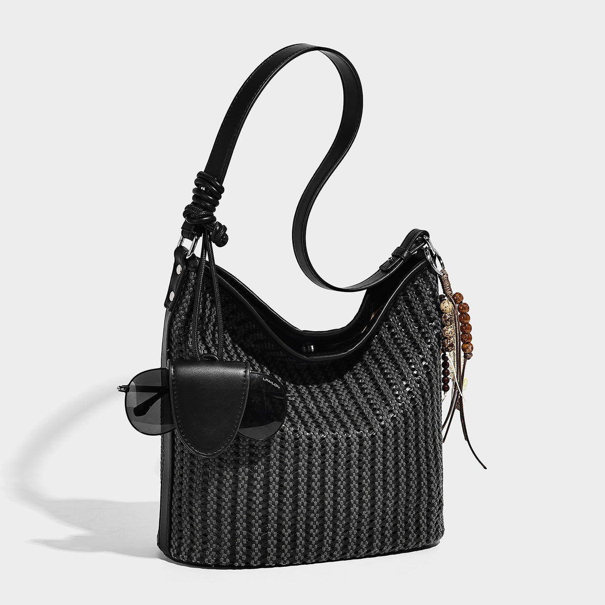 Slouchy open-weave hobo shoulder bag with leather-look trim, beaded tassel charm, and adjustable strap, detail view 4