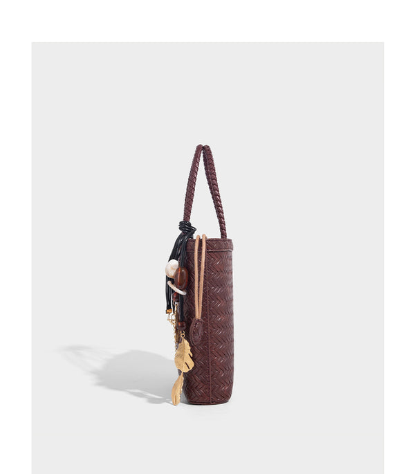 Small structured woven-texture tote bag with braided top handles and drawstring inner pouch, detail view 17