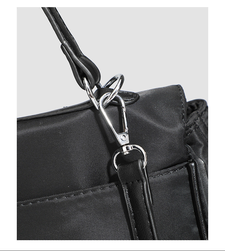 Structured black leather-look flap satchel bag with silver turn-lock hardware and top handle, detail view 30