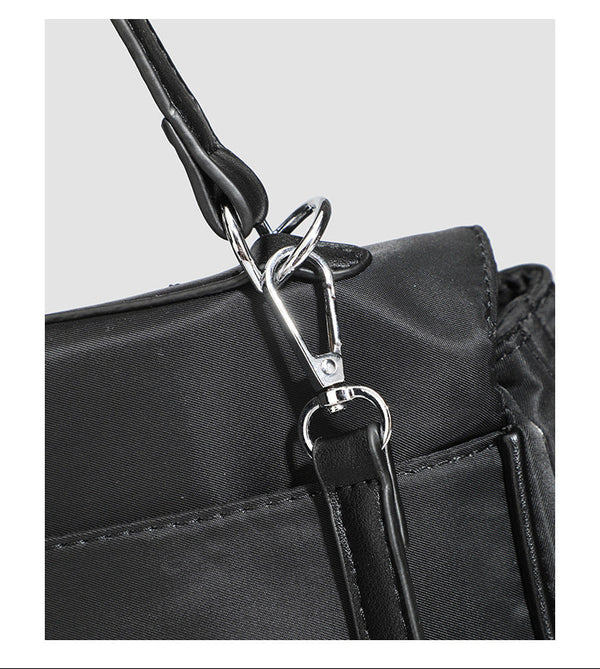 Structured black leather-look flap satchel bag with silver turn-lock hardware and top handle, detail view 30