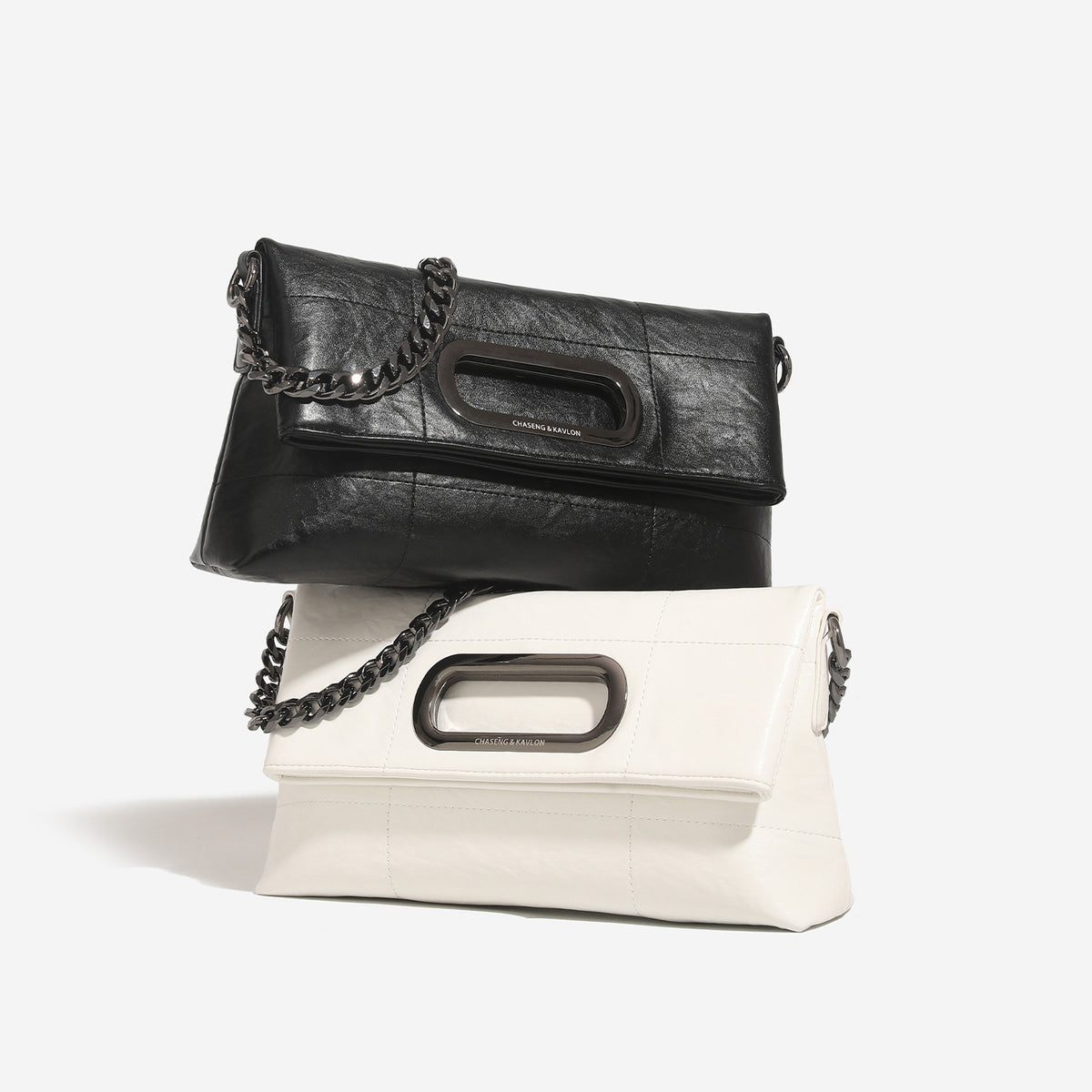 Soft rectangular leather-look convertible shoulder bag with dark curb-chain strap and rounded rectangular metal handle