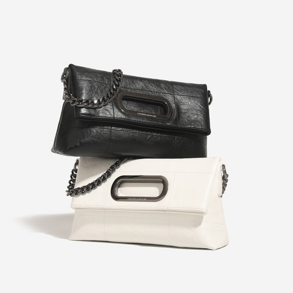 Soft rectangular leather-look convertible shoulder bag with dark curb-chain strap and rounded rectangular metal handle