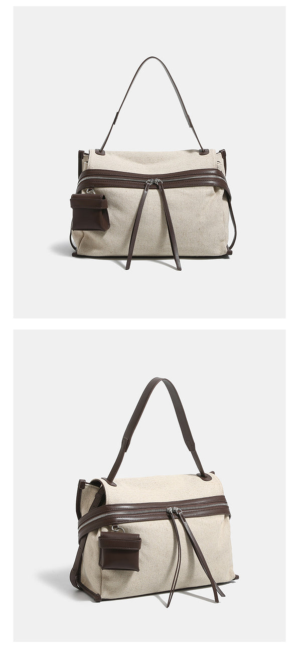 Off-white woven cotton-linen shoulder bag with brown leather-look trim, dual zip closure, long zipper pulls, front exterior