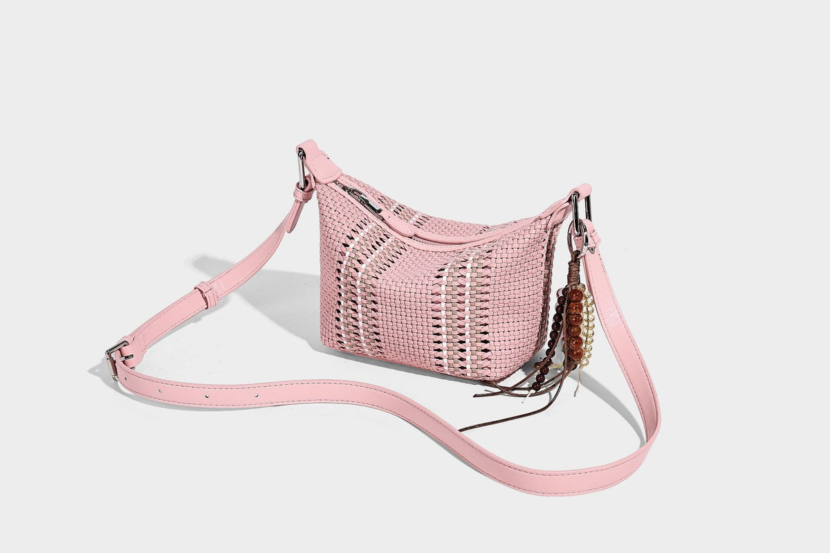 Small woven crescent shoulder bag with leather-look trim, zip closure, silver-tone ring hardware, and beaded tassel charm
