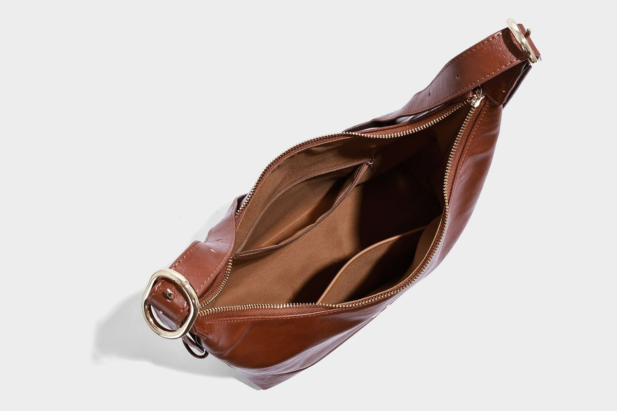 Glossy leather-look slouchy hobo shoulder bag with zip closure, gold-tone hardware, and adjustable strap, detail view 24