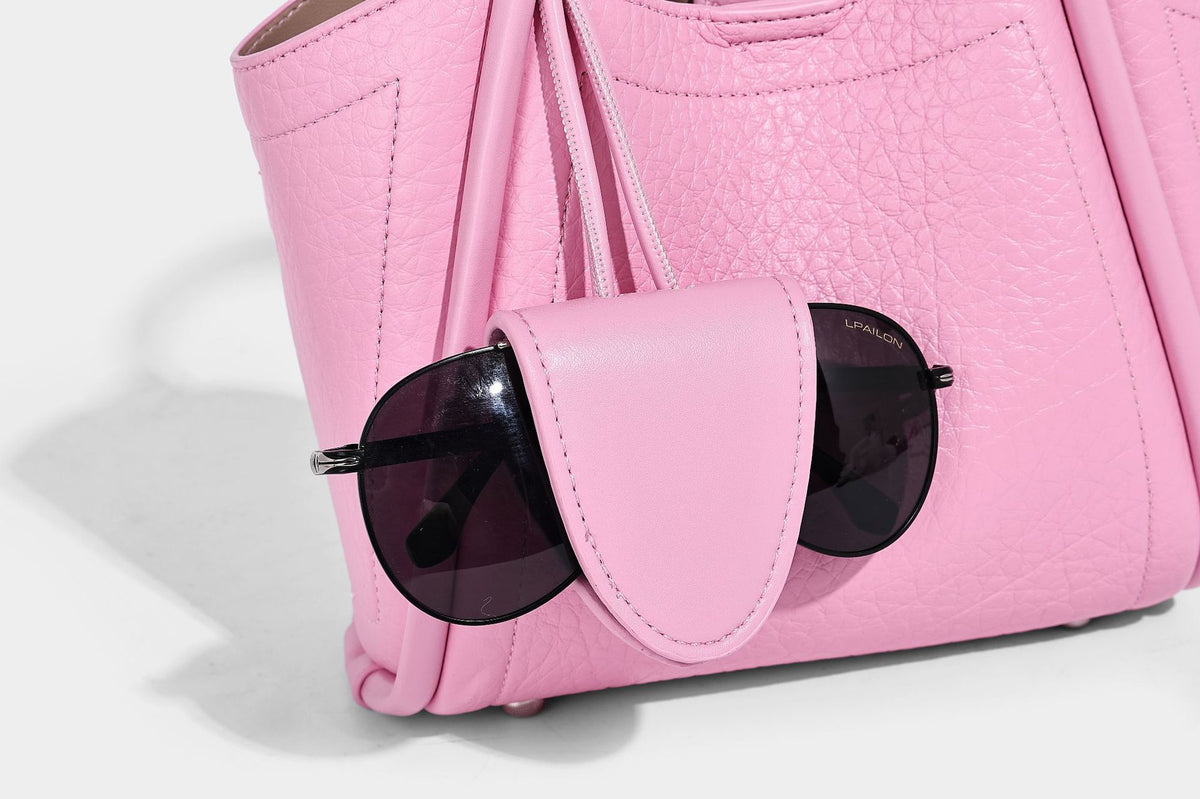 Structured mini tote bag in pebbled leather-look finish with knotted top handles, front flap pocket, and detachable shoulder