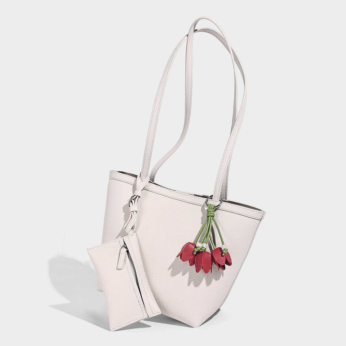Structured pebbled leather-look tote bag in taupe with long shoulder strap, detachable zip pouch, and pink tulip flower