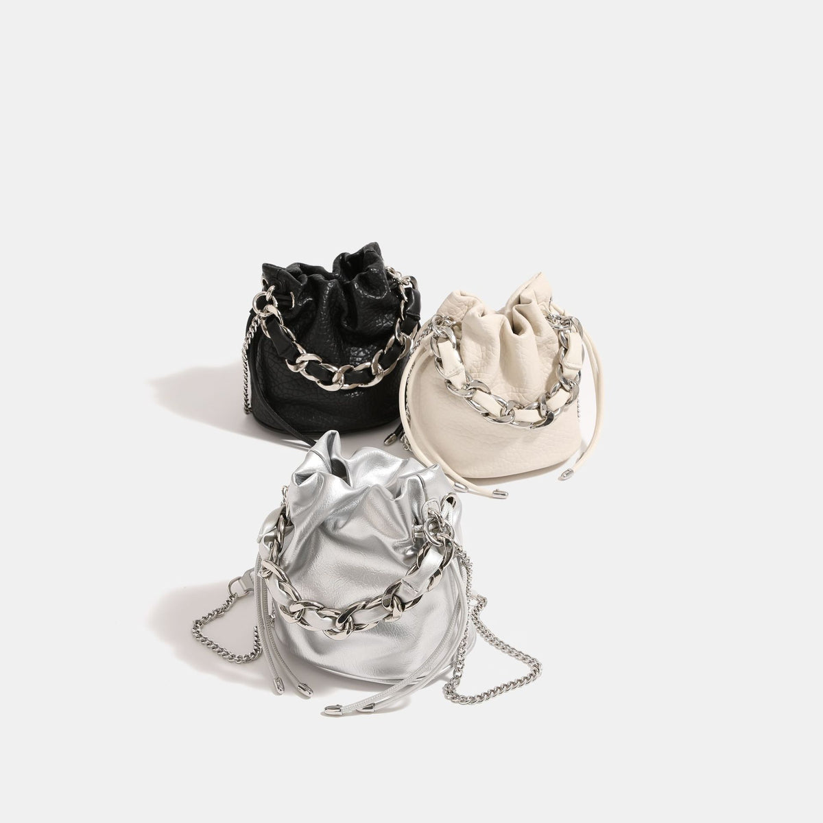 Small ruched drawstring bucket bag with chunky woven chain top handle and fine-link crossbody strap, detail view 2