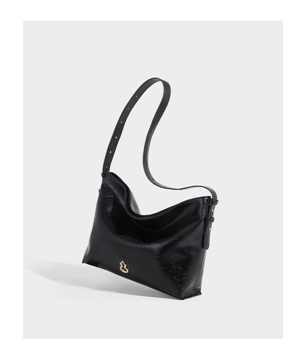 Large slouchy hobo shoulder bag in glossy crinkle leather-look finish with gold-tone emblem hardware and adjustable strap