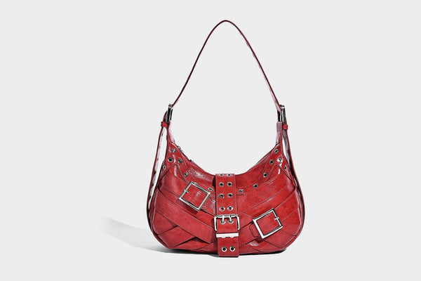 Glossy crescent hobo bag with silver-tone grommets, square buckle straps, and top zipper closure, detail view 10