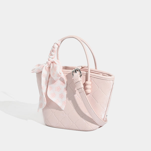 Quilted leather-look mini tote bag with printed scarf bow on braided top handle and silver-tone hardware, detail view 3