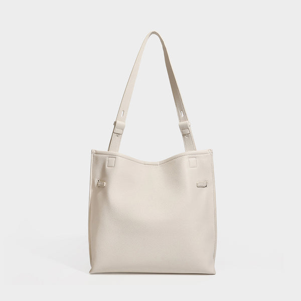 Large structured tote bag in pebbled leather-look finish with silver-tone twist-knot front detail and adjustable shoulder
