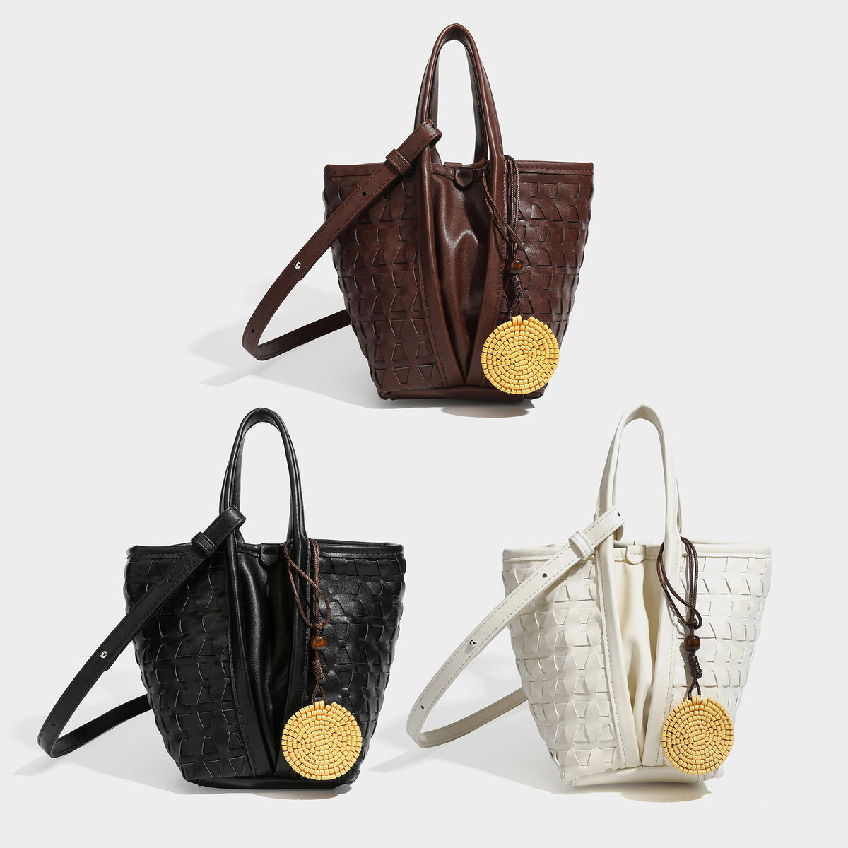 Small brown woven-texture bucket tote bag with drawstring closure, top handles, detachable shoulder strap, and round disc