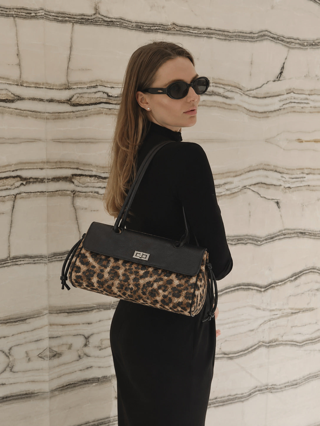 Compact two-tone quilted shoulder bag with black leather-look flap, silver turn-lock clasp, diamond-quilted body, side
